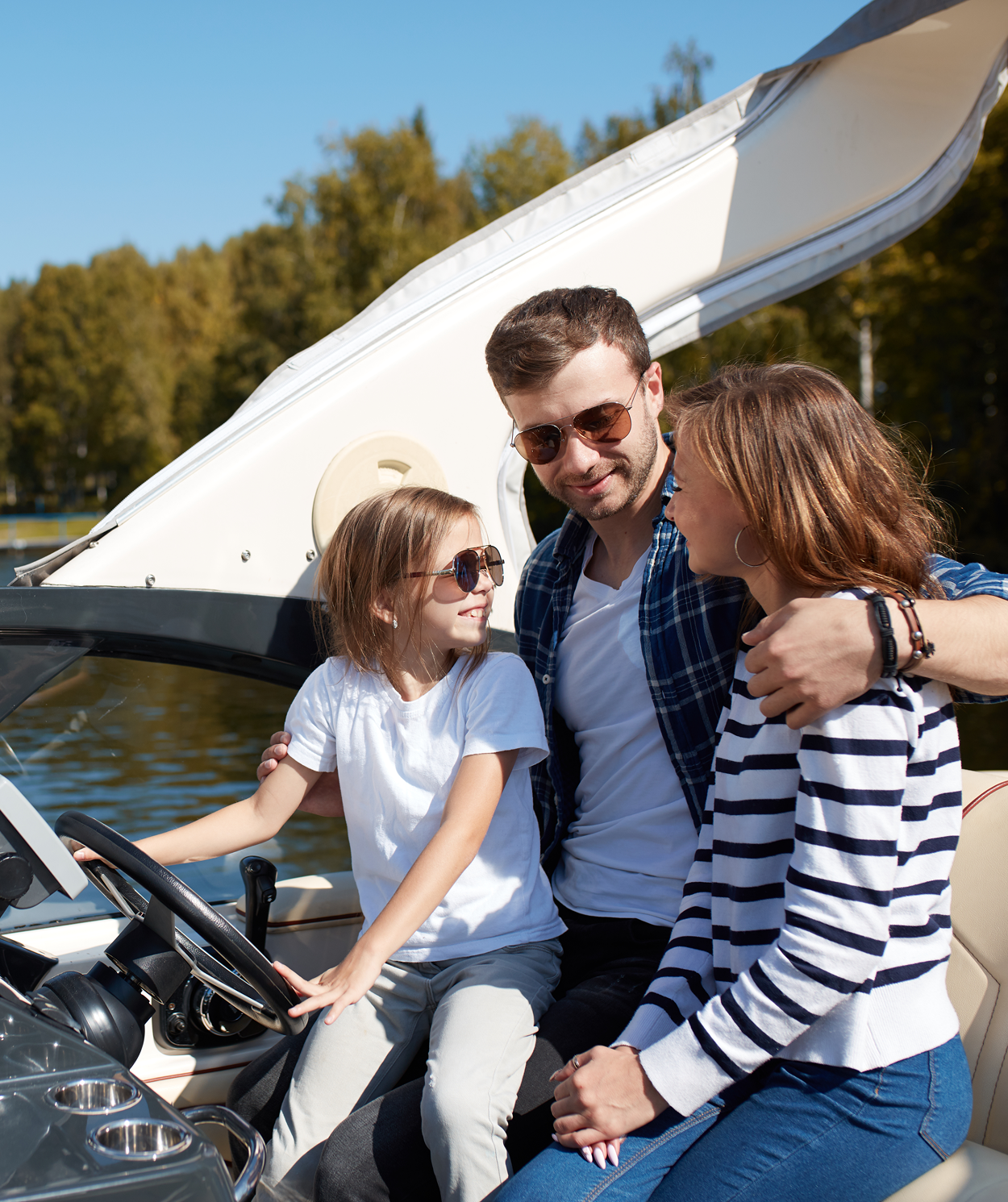 A man and two children are sitting on a boat.