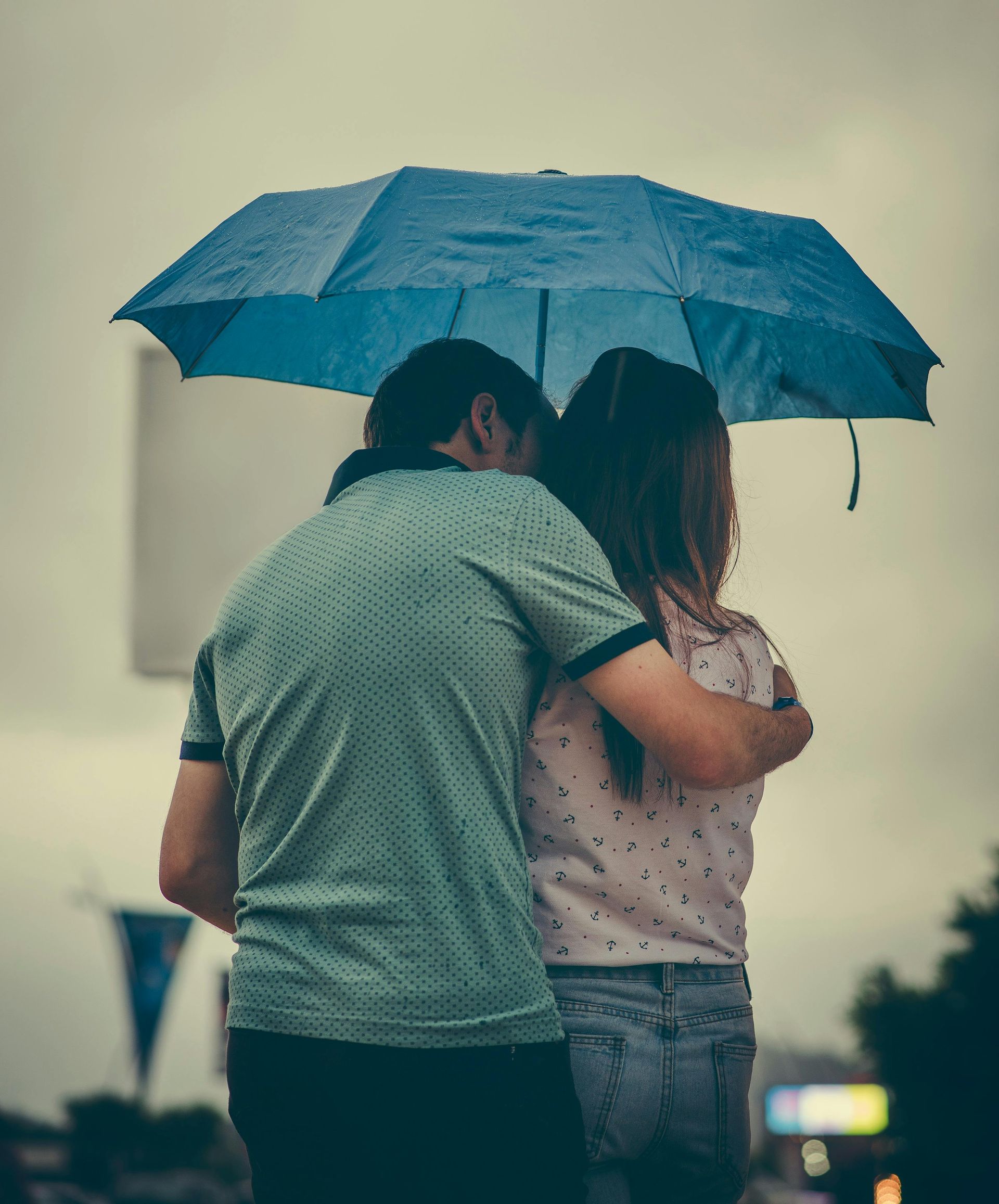 A man holding an umbrella while walking with a child