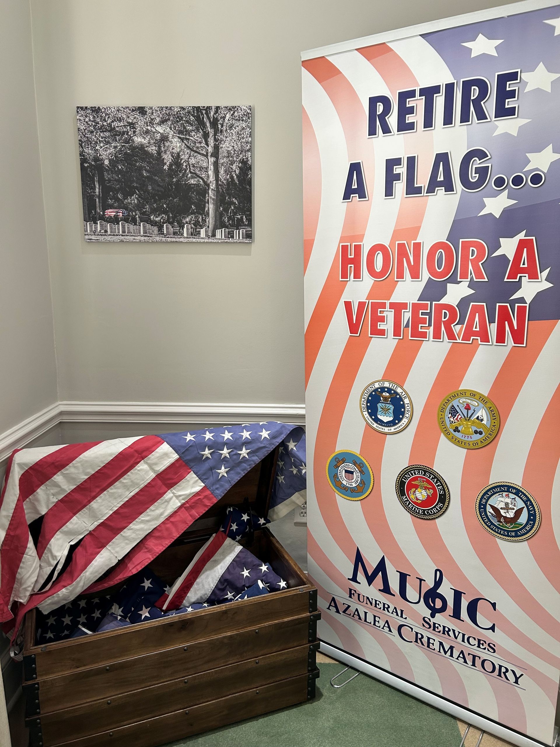 A room with an american flag and a sign that says `` retire a flag ... honor a veteran ''.