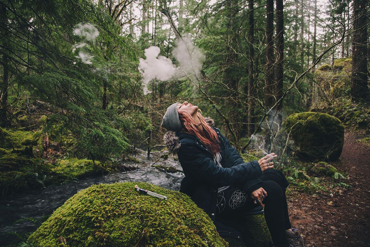 woman smoking in woods