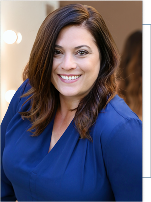 A woman in a blue shirt is smiling for the camera.