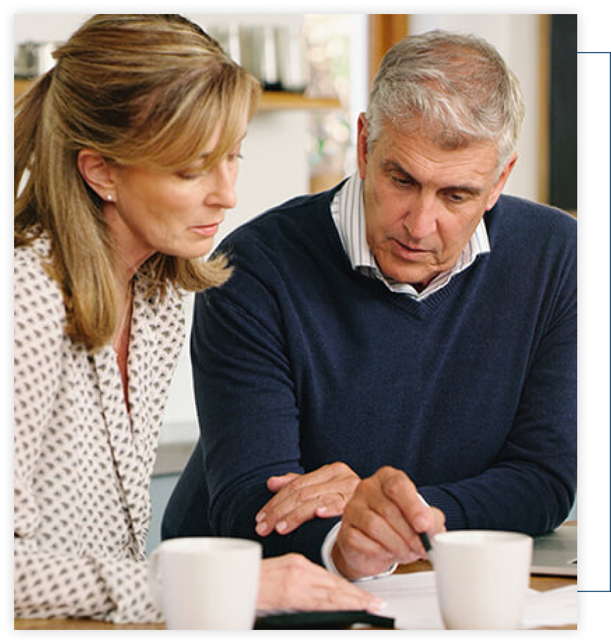 A man and a woman are looking at a piece of paper