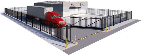 A red truck is parked in front of a fence.