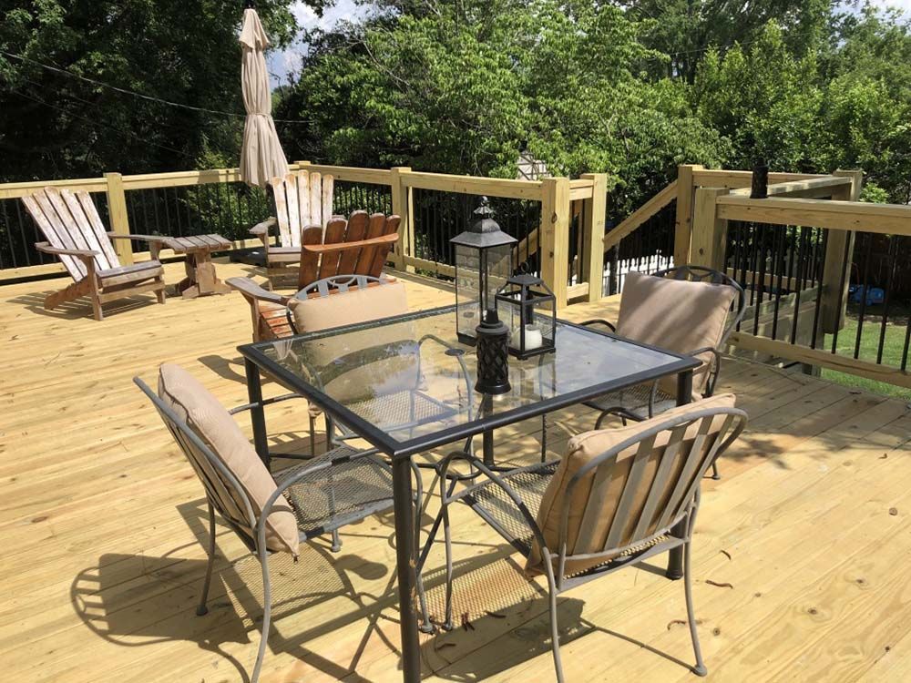 A wooden deck with a table and chairs on it