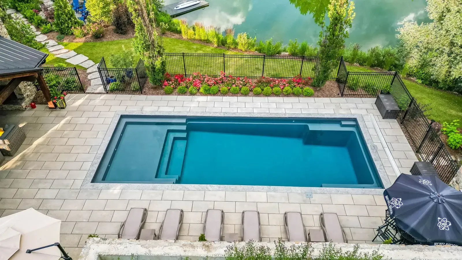 The Vision Pool Range with a side profile aerial view showing the splash pad, stps, seating, and depth. 