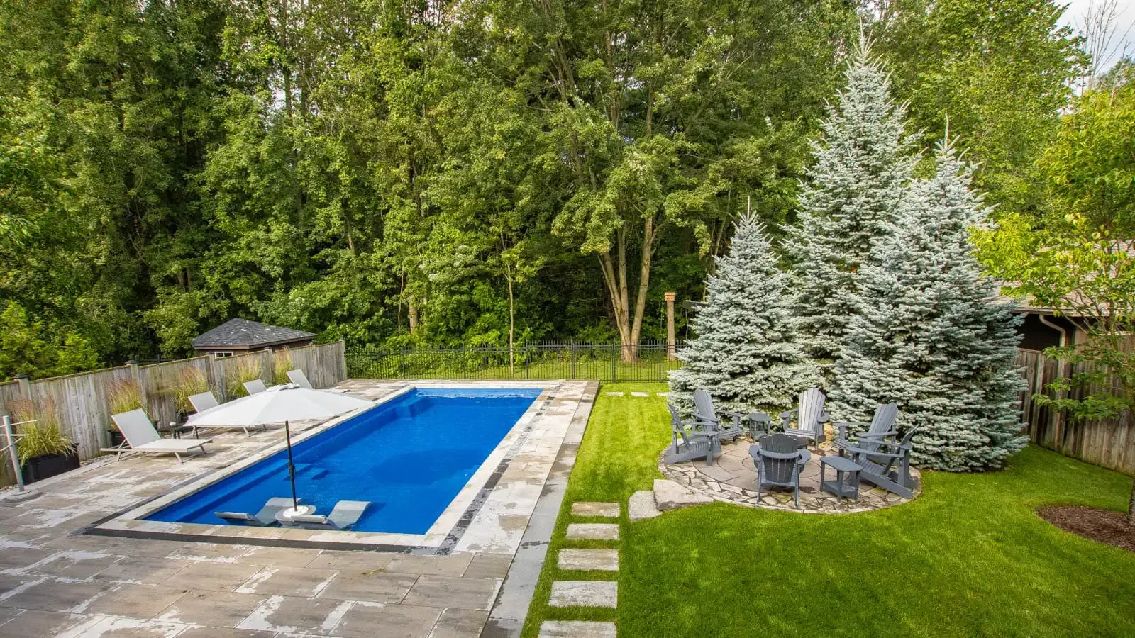 The Vision Pool Range in Ocean Blue with gorgeous hardscape and landscaping to copmlement it
