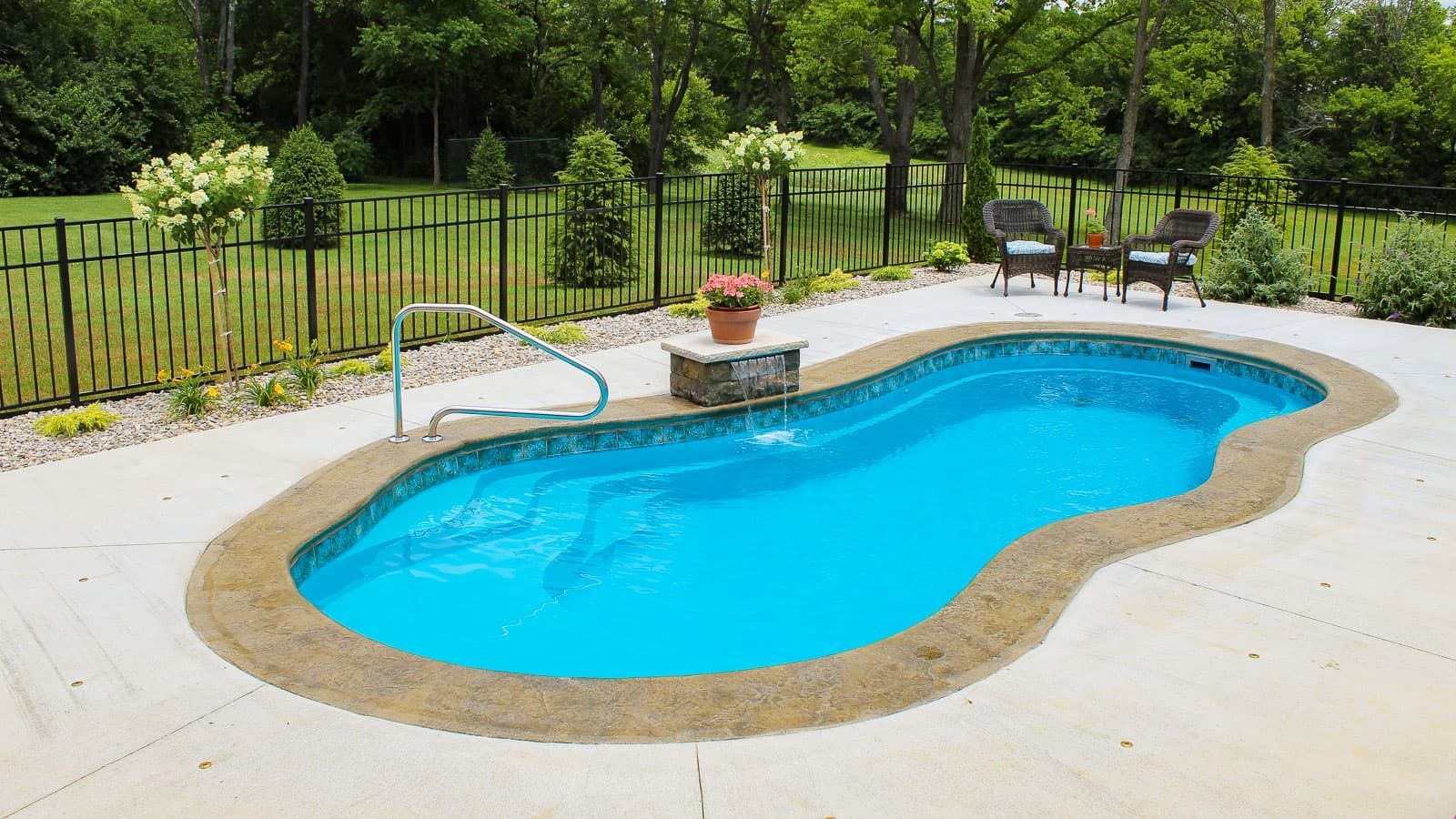 A large blue swimming pool is sitting on top of a concrete patio.