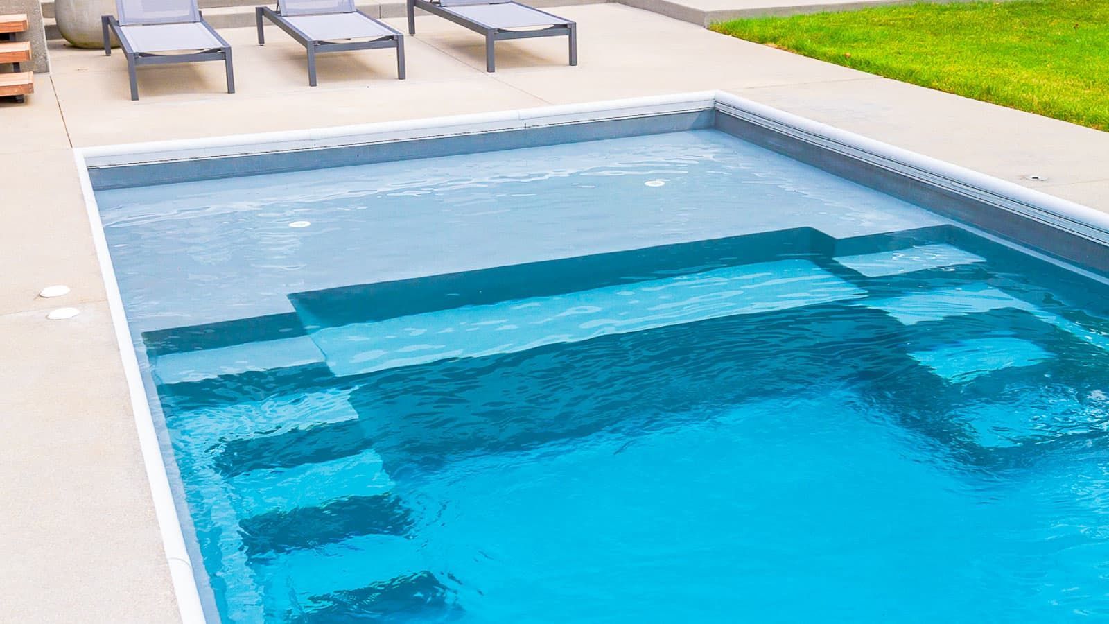 The Freedom Pool Range shallow wend with dual staircases and splash pad close-up