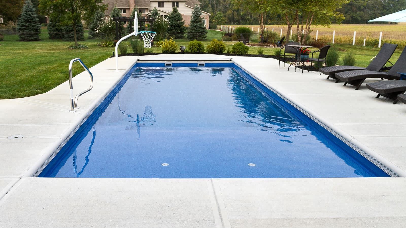 The Freedom Pool Range with a basketball goal for outdoor pool play.