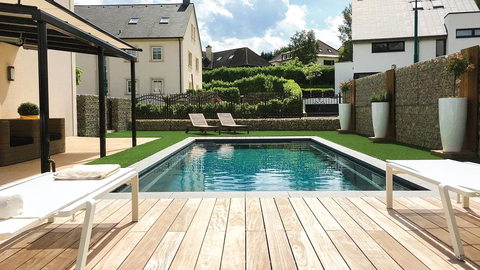 The Freedom Pool Range in a beautiful small yard with a custom deck built by Poo Boy