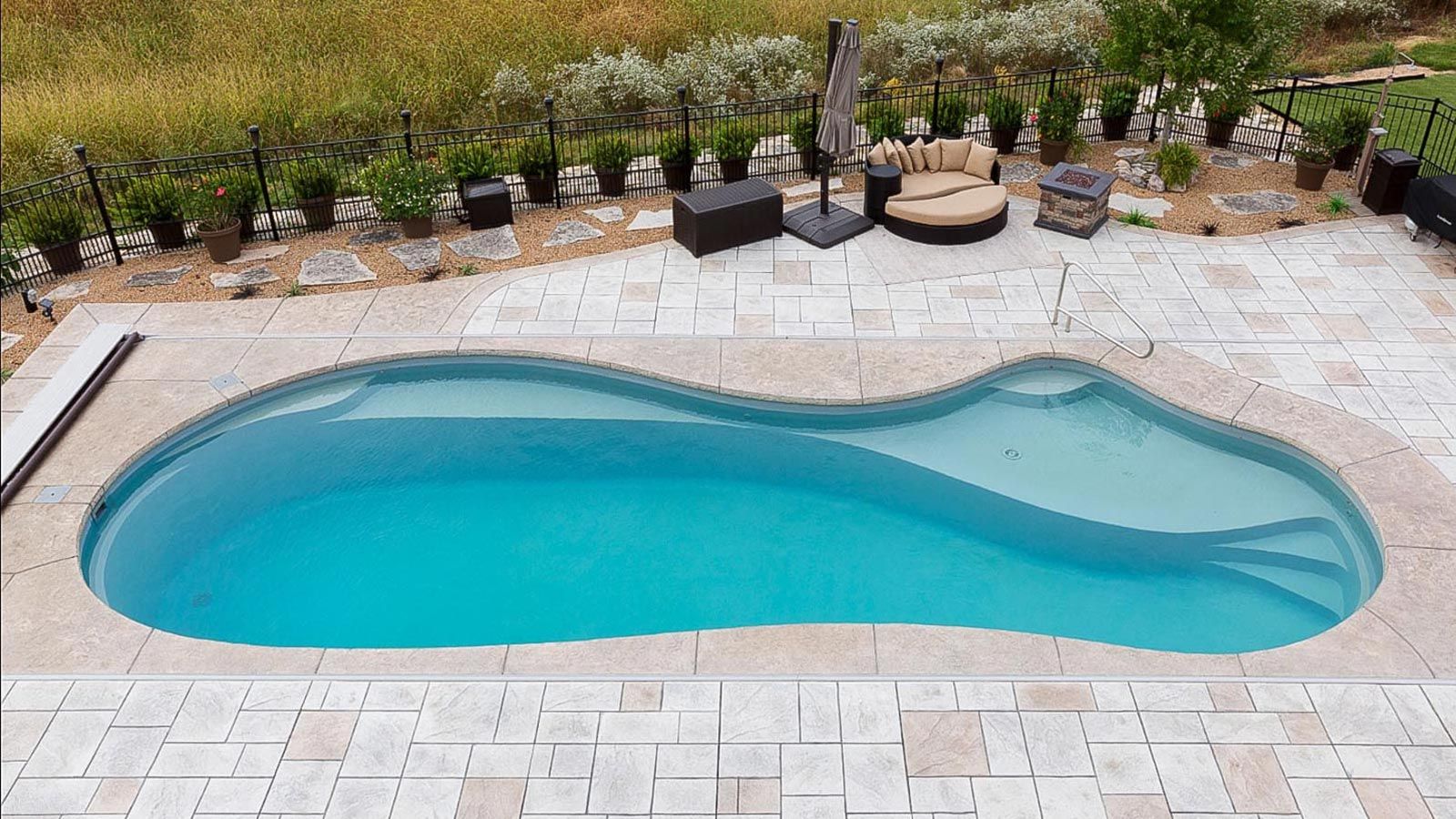 Side profile of The Inspiration Pool Range showing stairs and ample seating within the pool. 