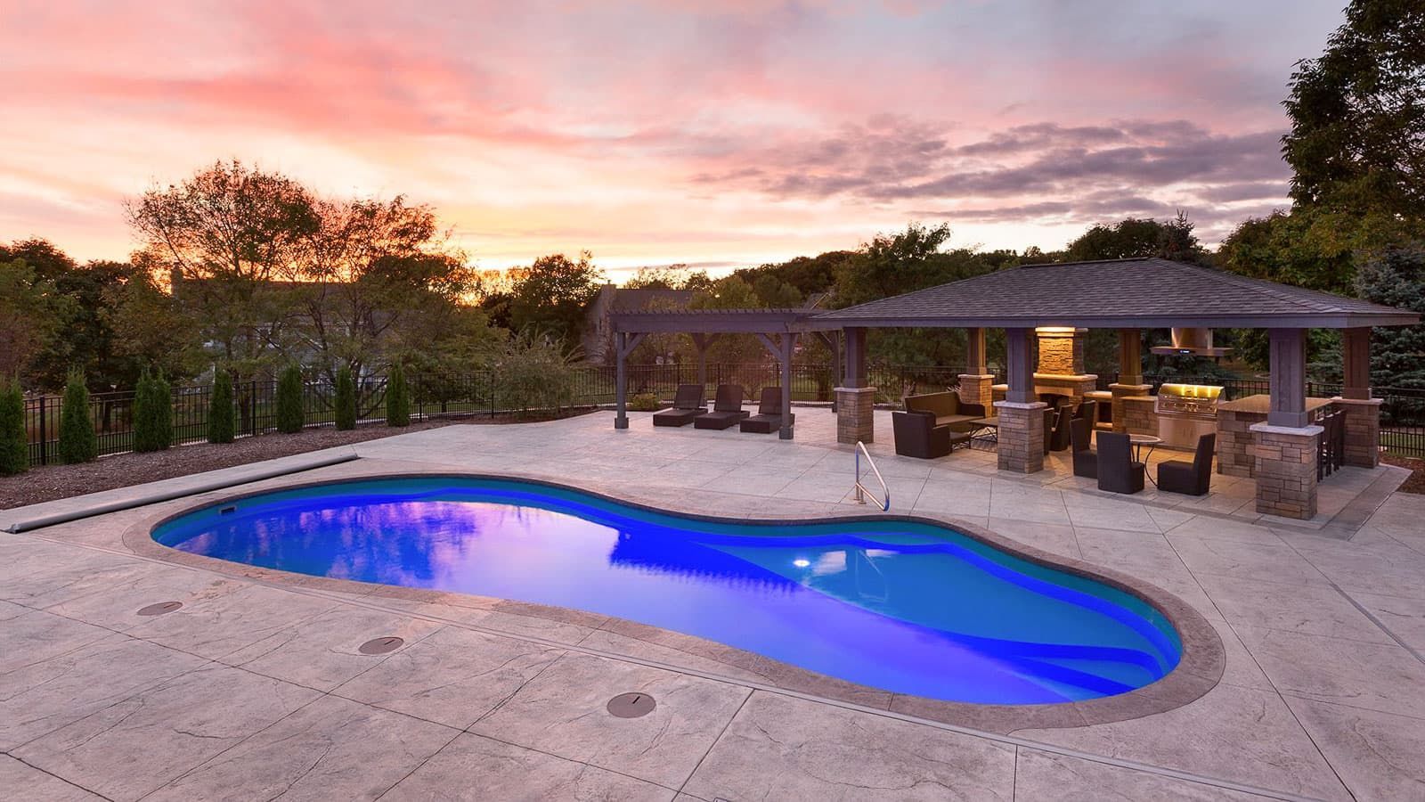 A large swimming pool with a gazebo in the background