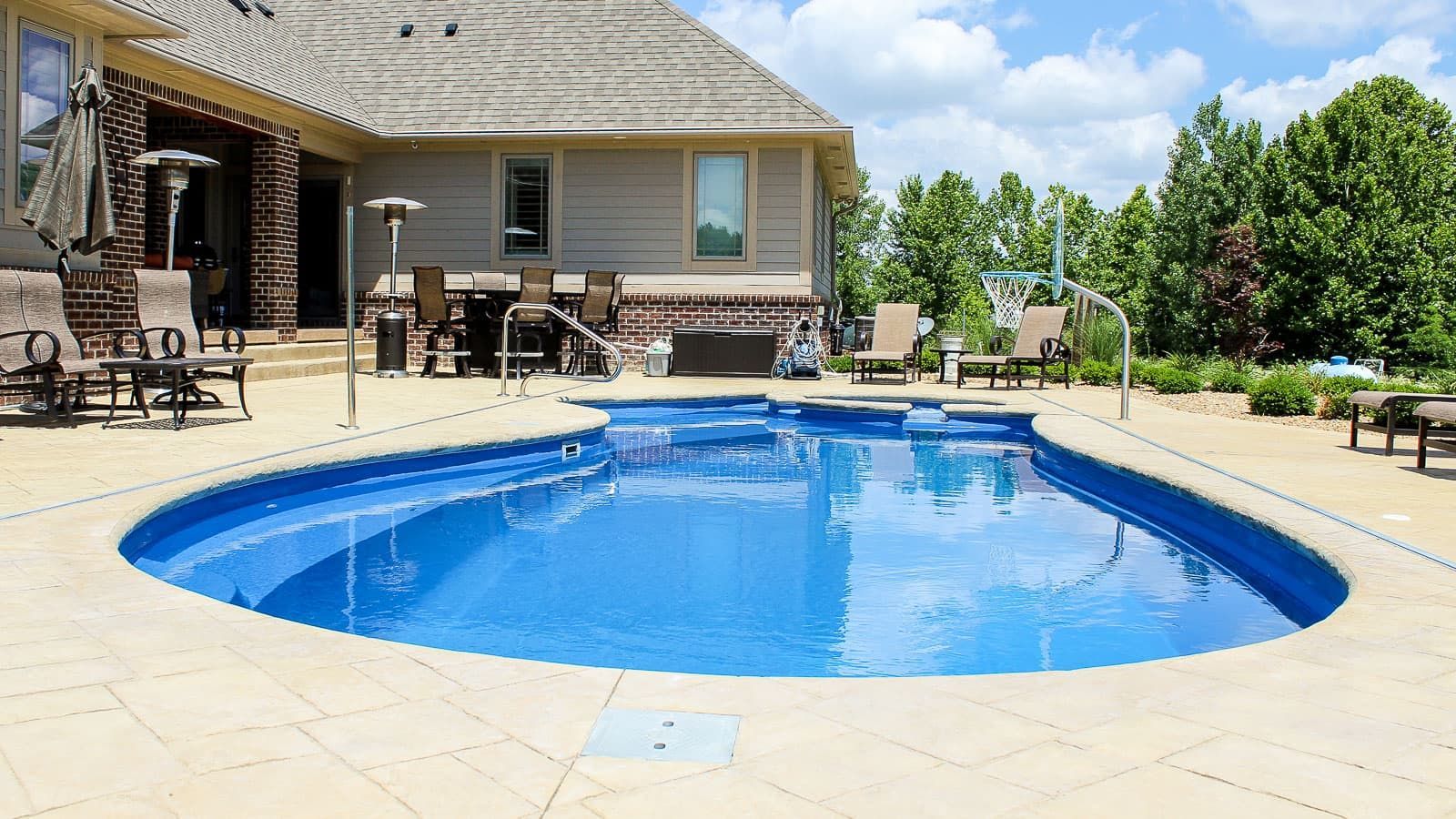 The Brilliant Pool Layout with a gorgeous hardscape and landscape surrounding it