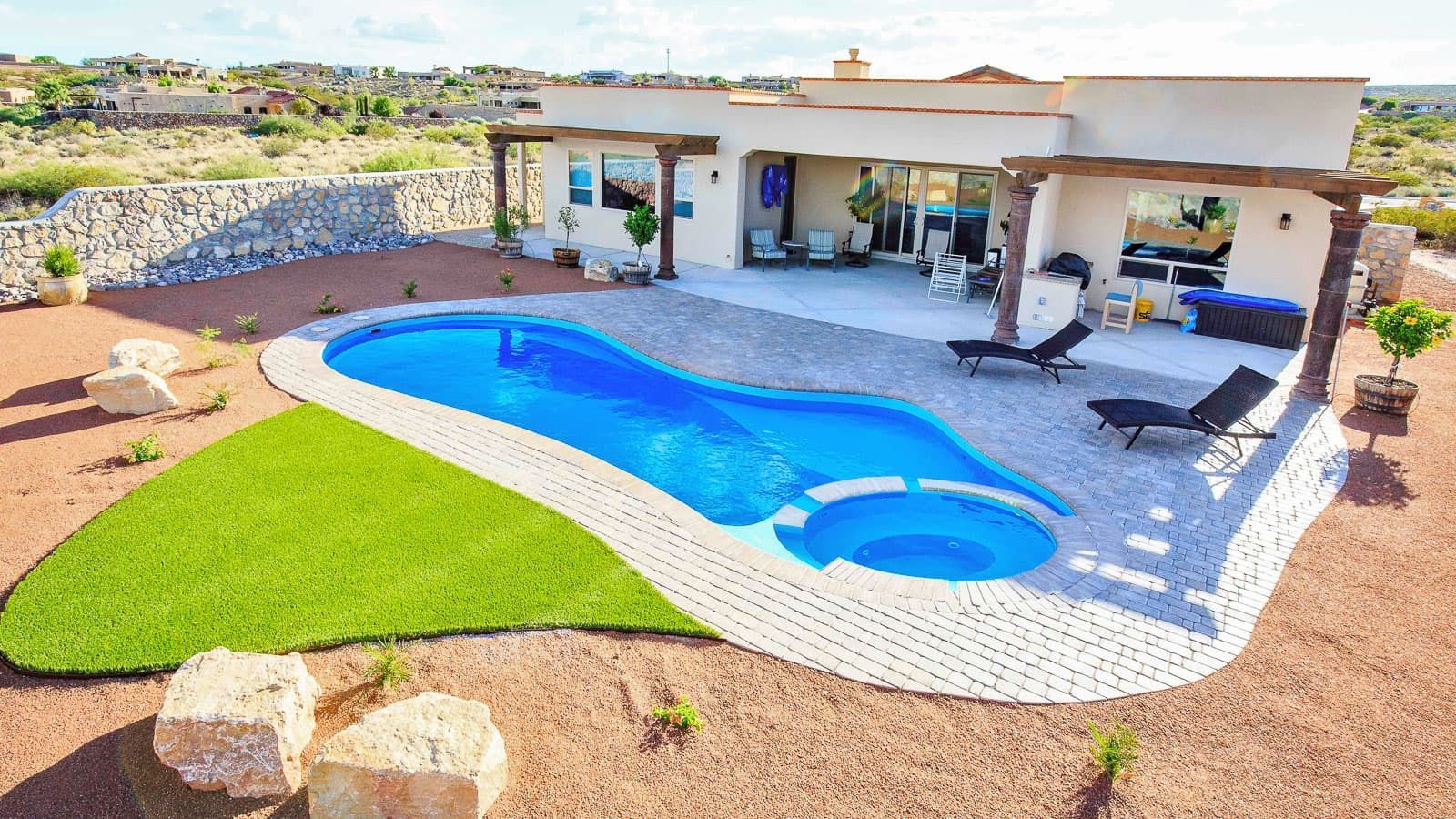The Brilliant Pool Layout with stone walkways and a back porch constructed by Poor boy