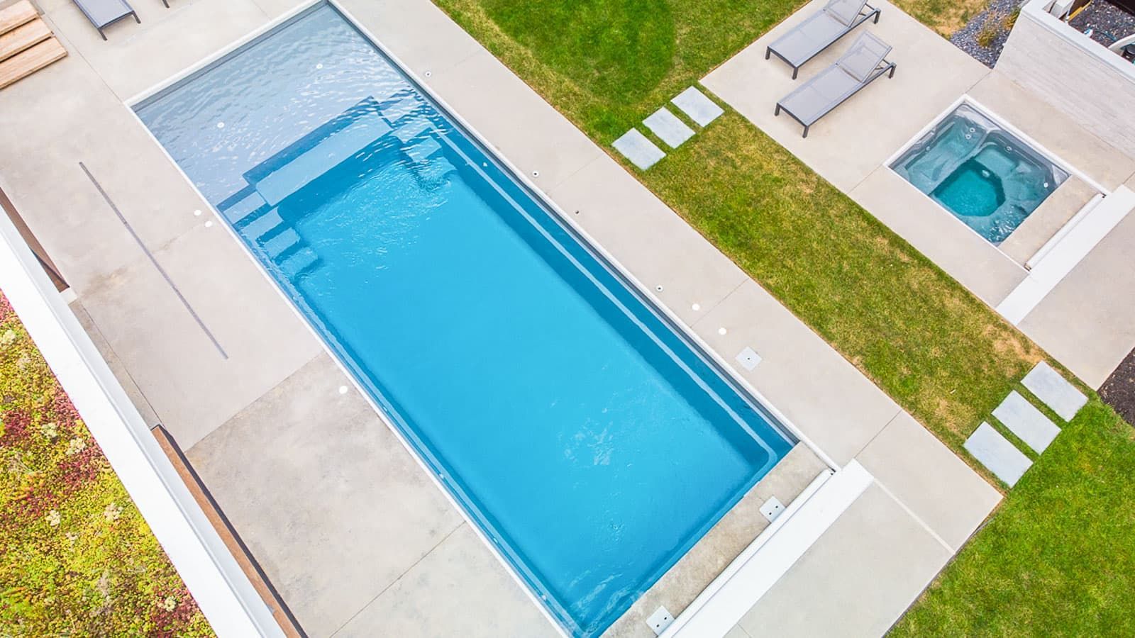 An aerial view of a large swimming pool in a backyard.
