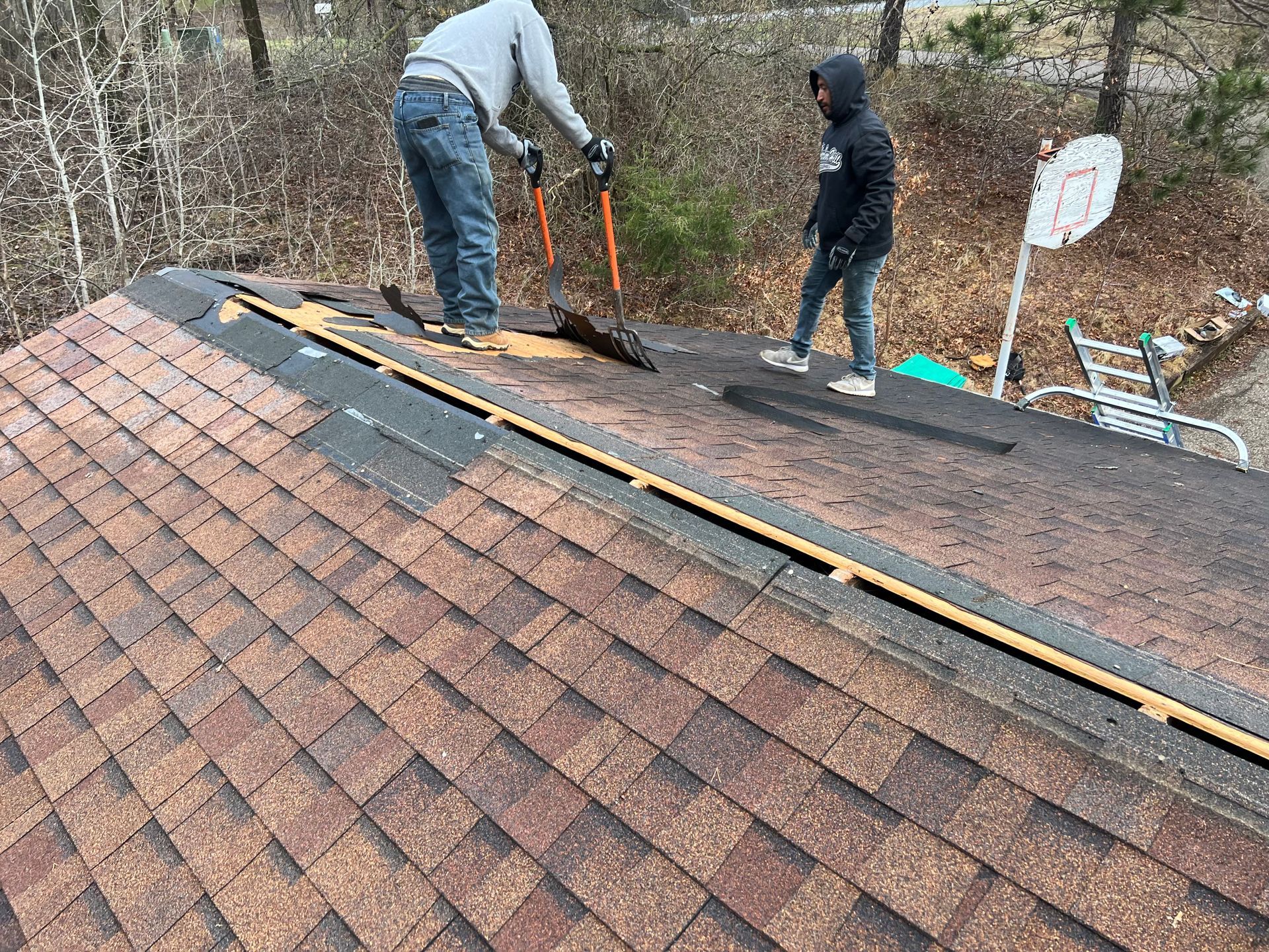 Fixing The Roof With Hammer And Nail | New Richmond, WI | DC Roofing Inc.