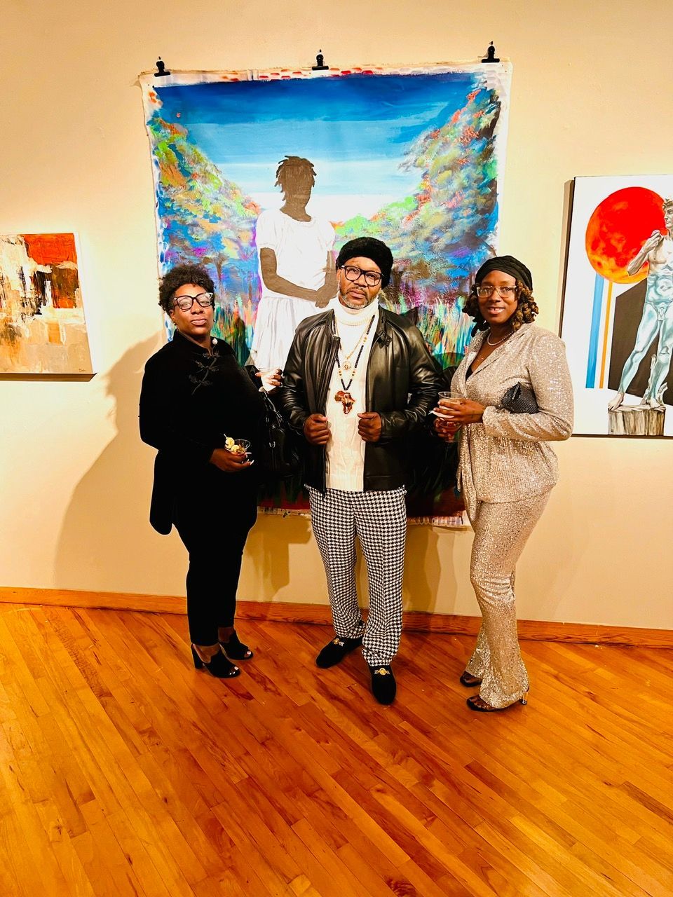 Three people are standing in front of a painting in a museum.