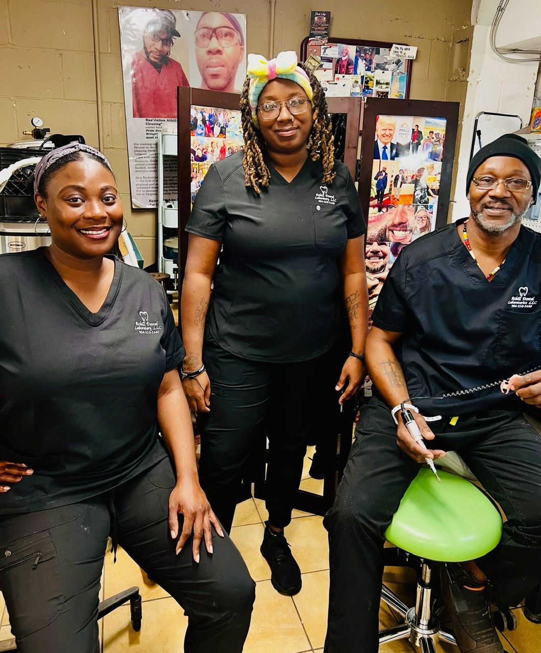 Three people wearing black scrubs are posing for a picture