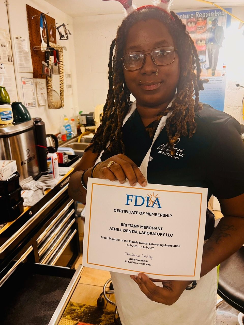 A woman is holding a certificate that says fdla