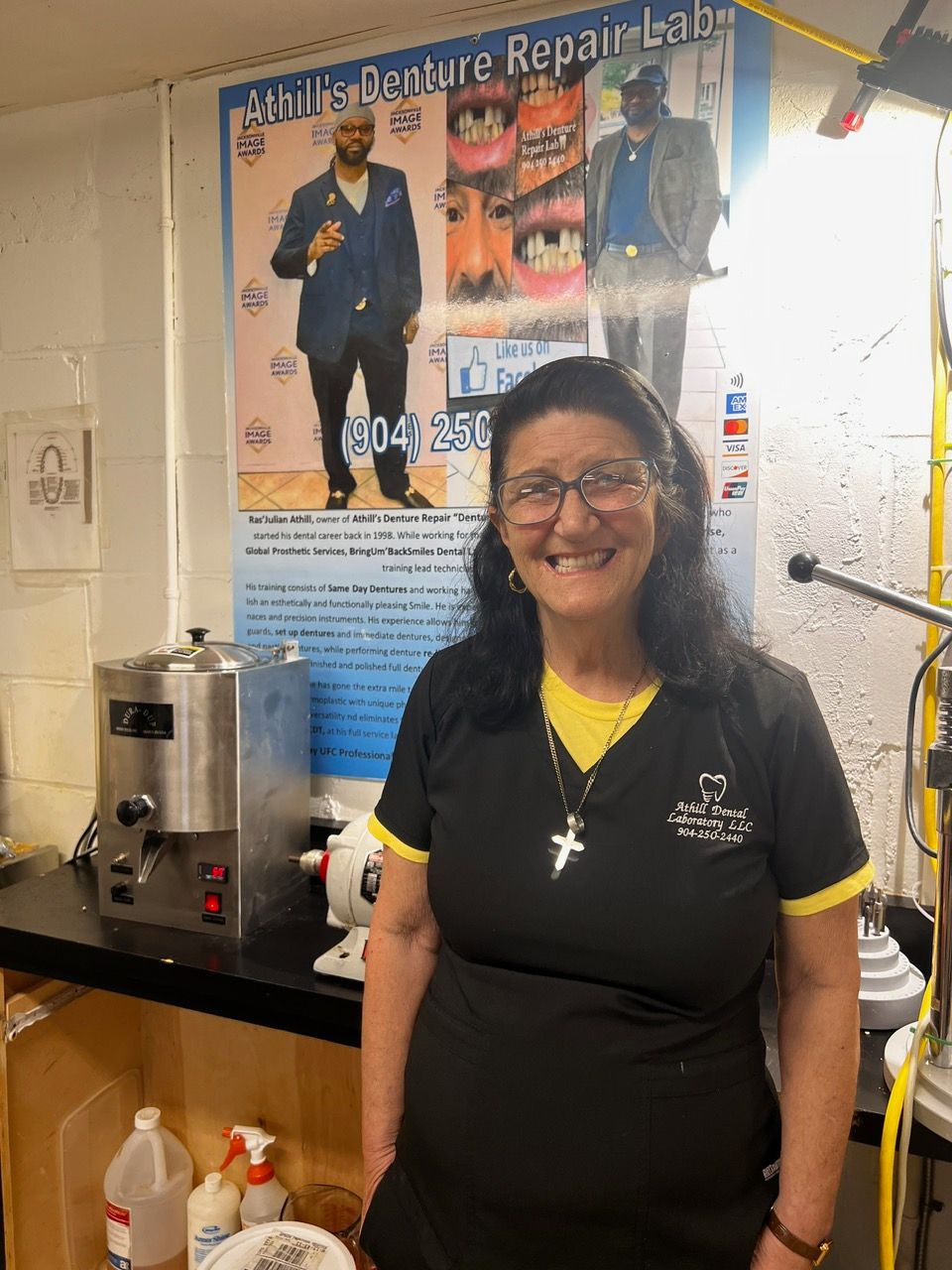 A woman in a black shirt is standing in front of a poster that says dental repair