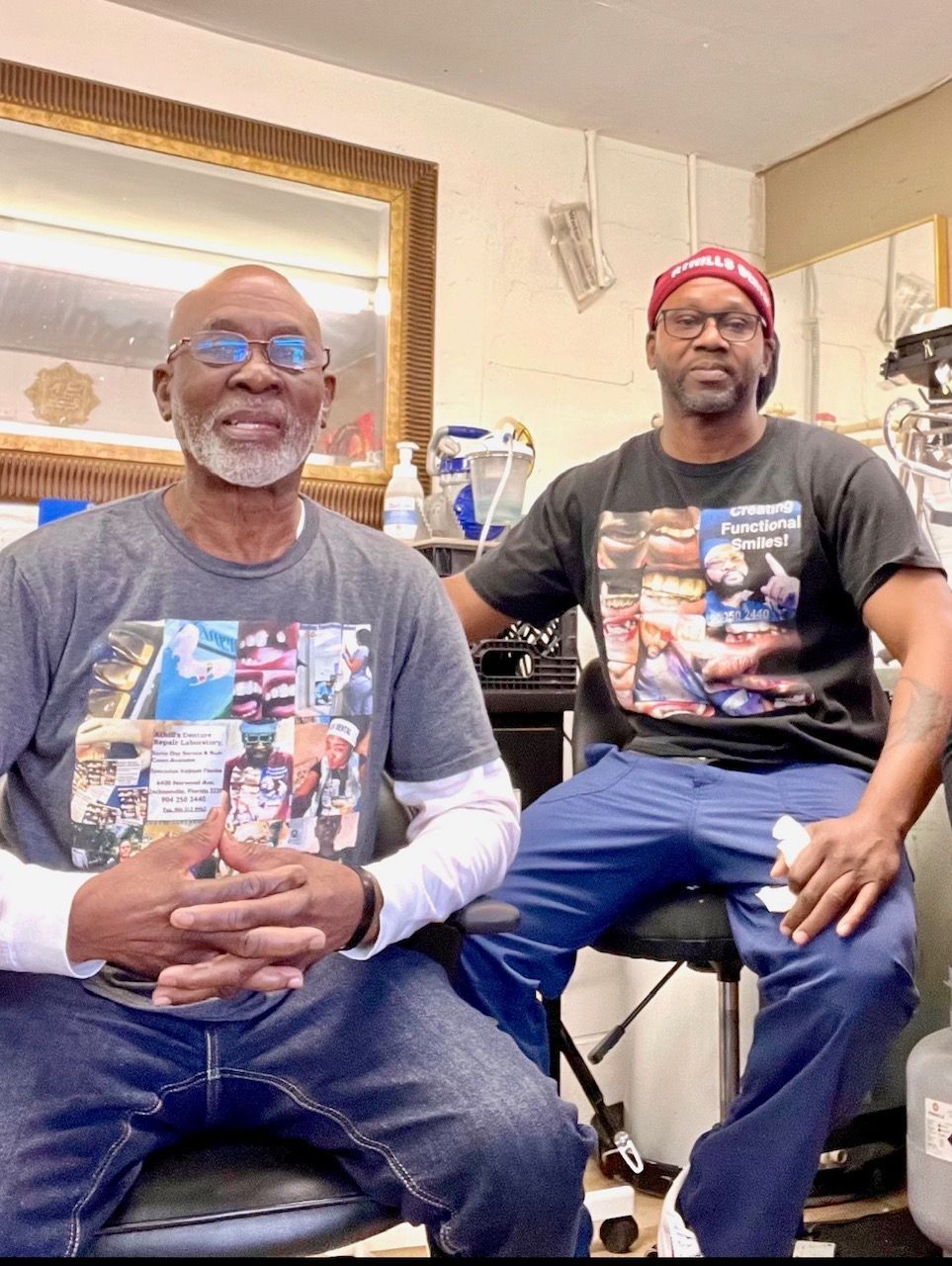 Two men are sitting next to each other in a room.