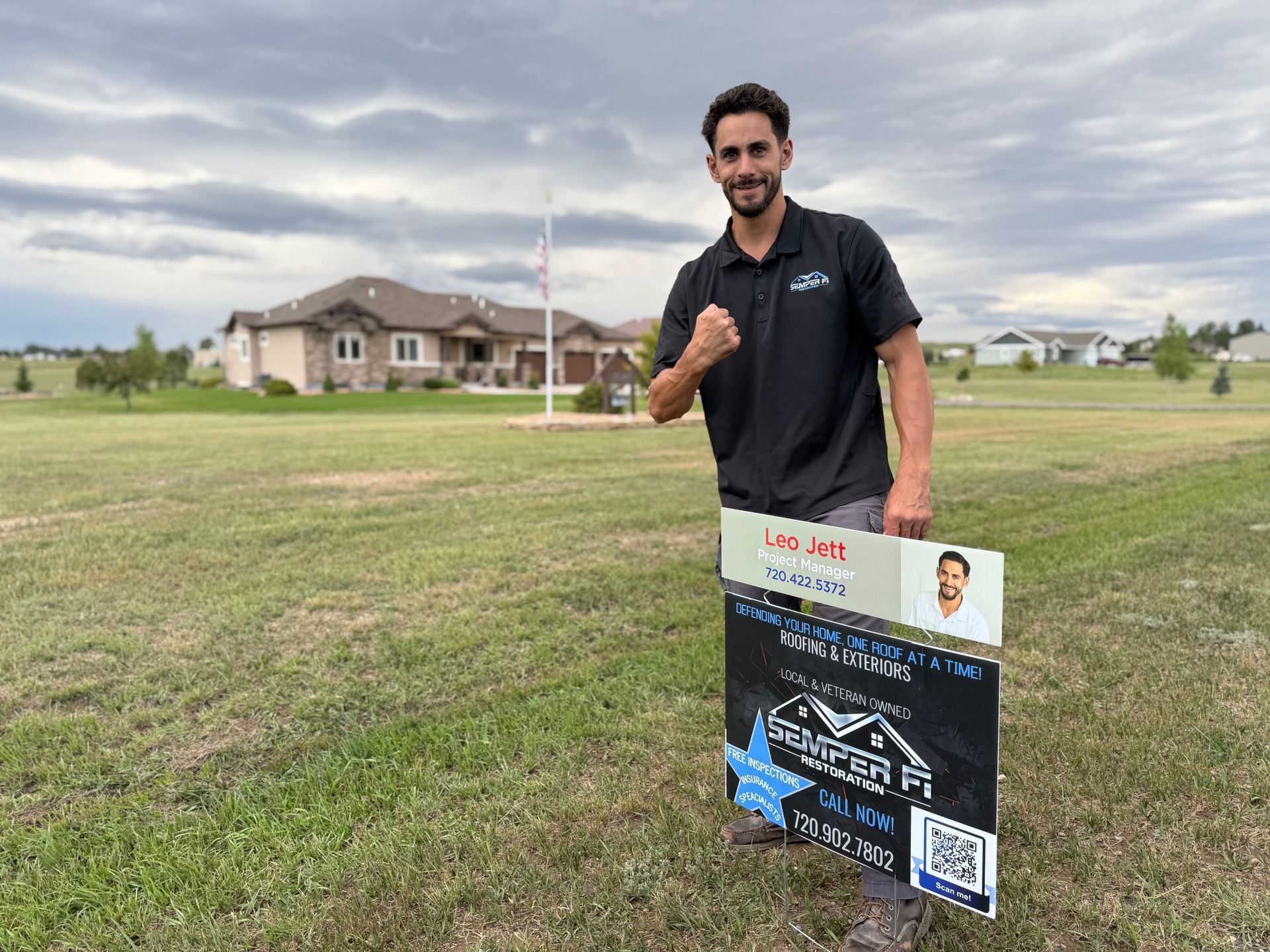 A real estate agent stands in front of a house holding a 