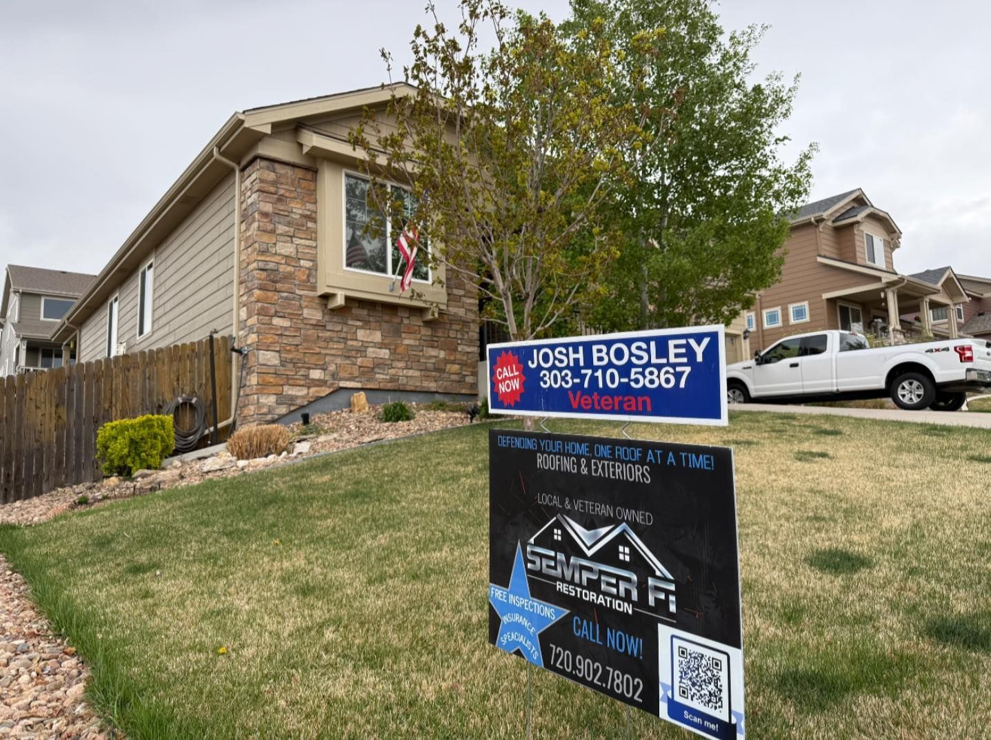 A house with a for sale sign in front of it.
