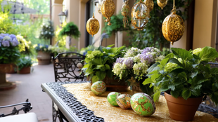 Outdoor patio with table, plants, and hanging golden decorations.