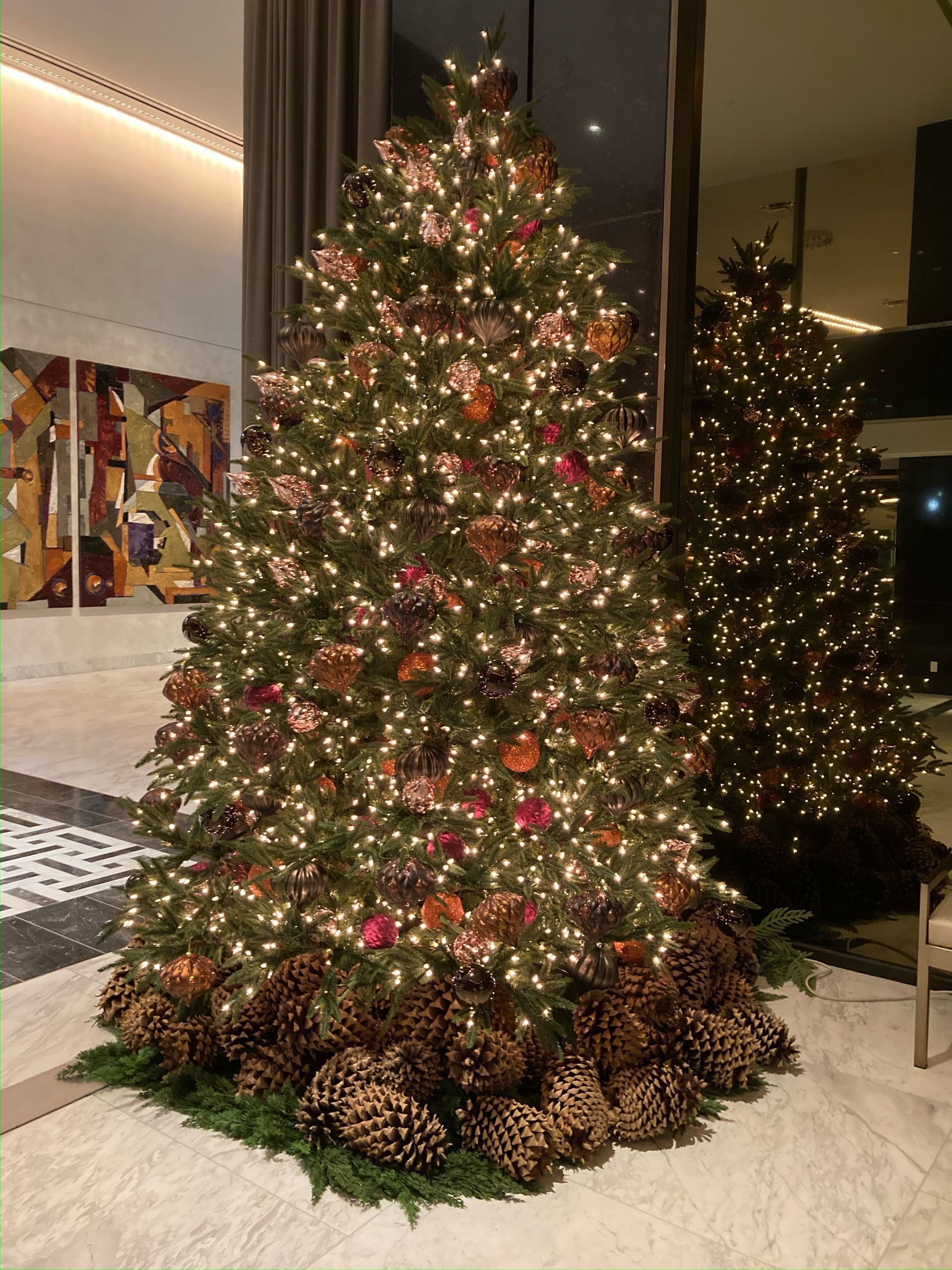 Elegant table setting with gold candle holders, floral arrangements, and folded napkins.
