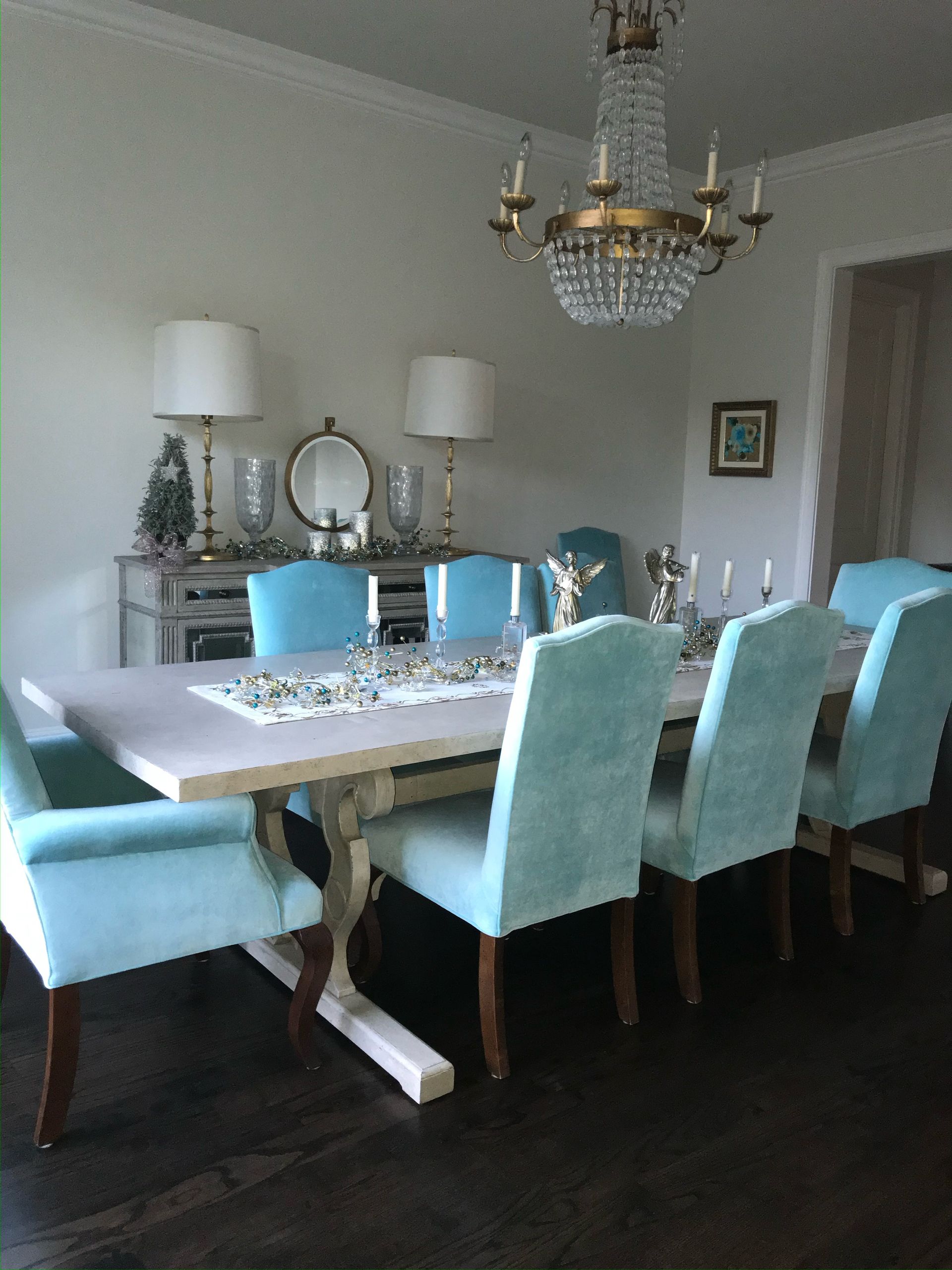 Christmas decorations: globe lights with holly and red berries over a kitchen island.