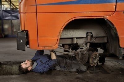 Mechanic under car