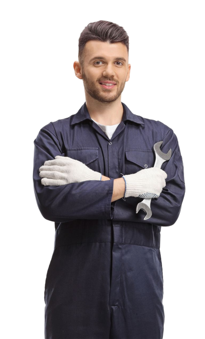 A smiling mechanic in navy blue work coveralls and white gloves, holding a wrench with arms crossed.