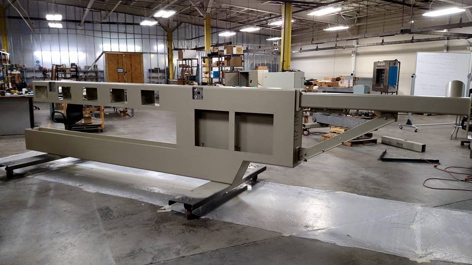 Industrial beige metal machine in a factory.