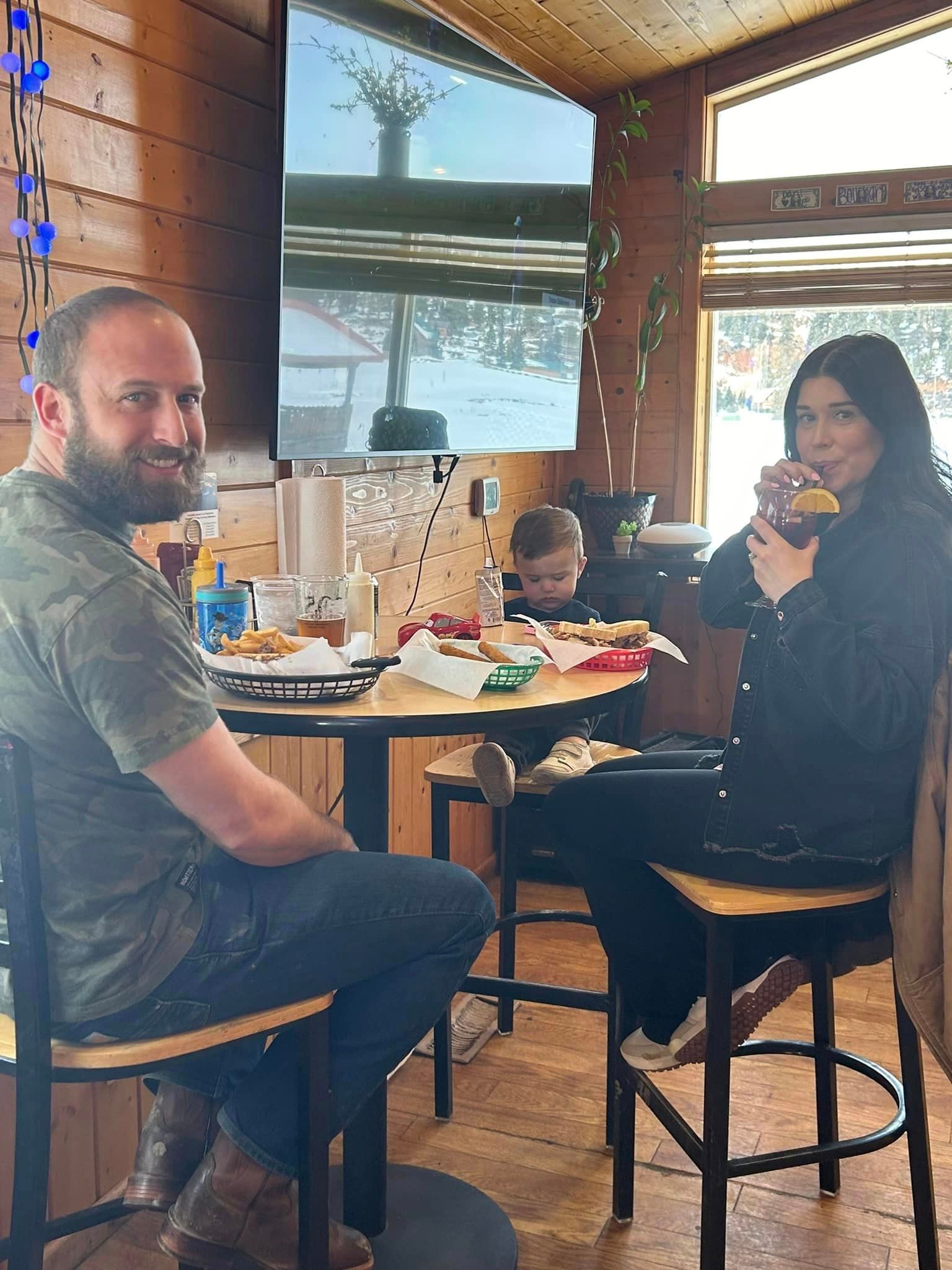 A man and a woman are sitting at a table in a restaurant.