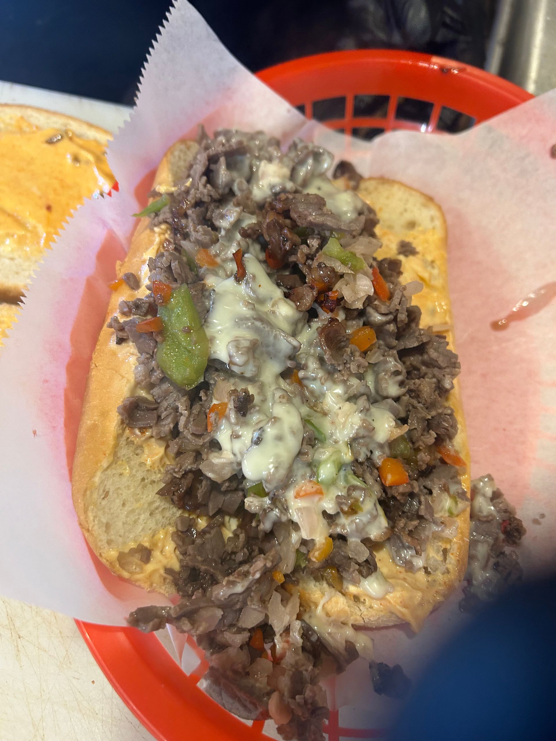 A close up of a steak sandwich in a basket
