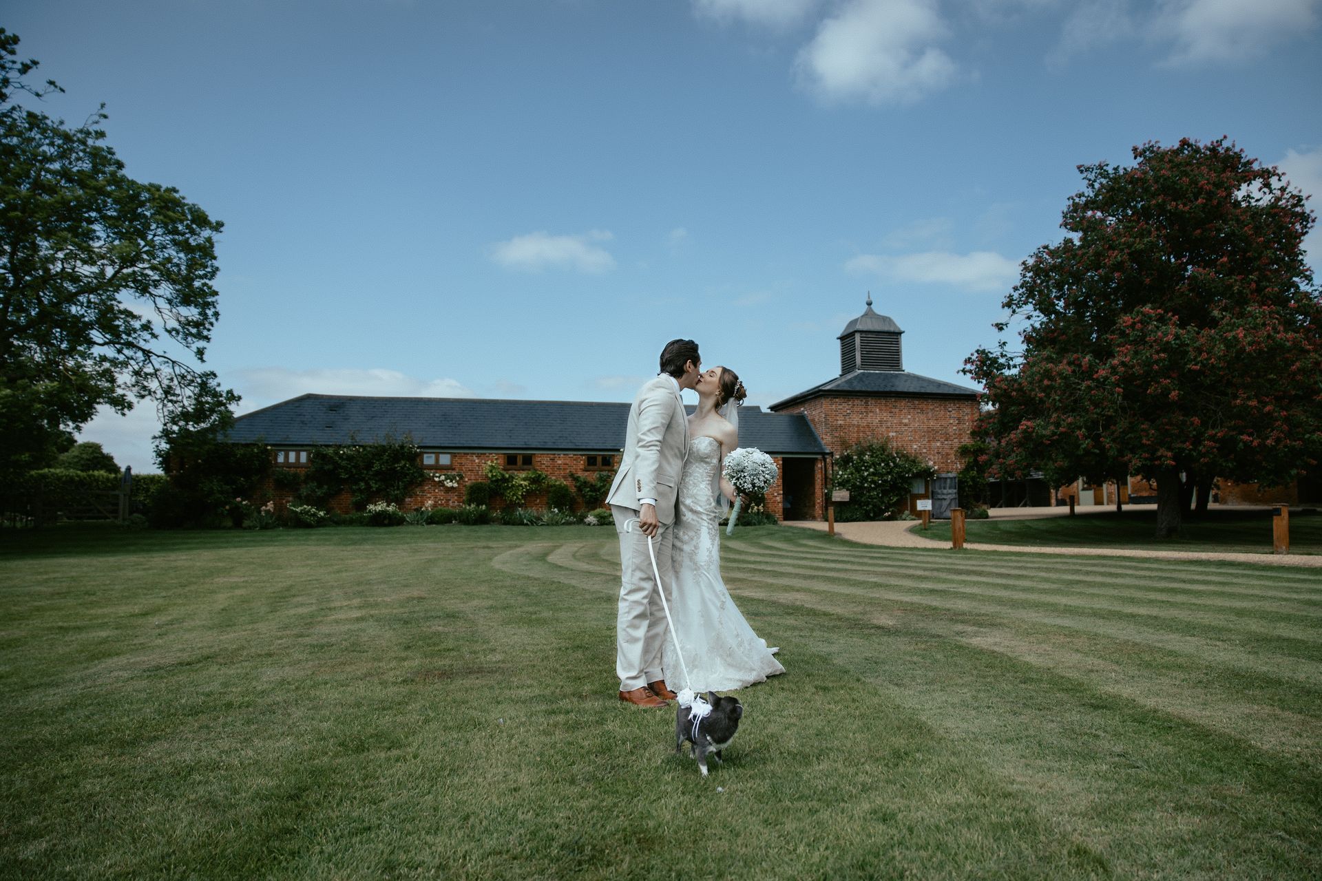 A bride and groom are holding hands and looking at each other.
