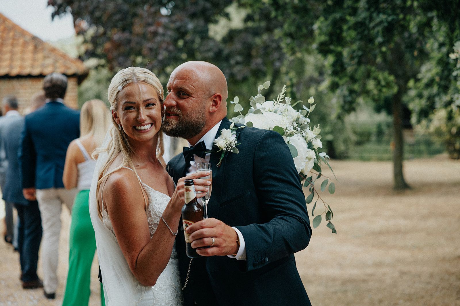 A bride and groom are posing for a picture at their wedding reception.