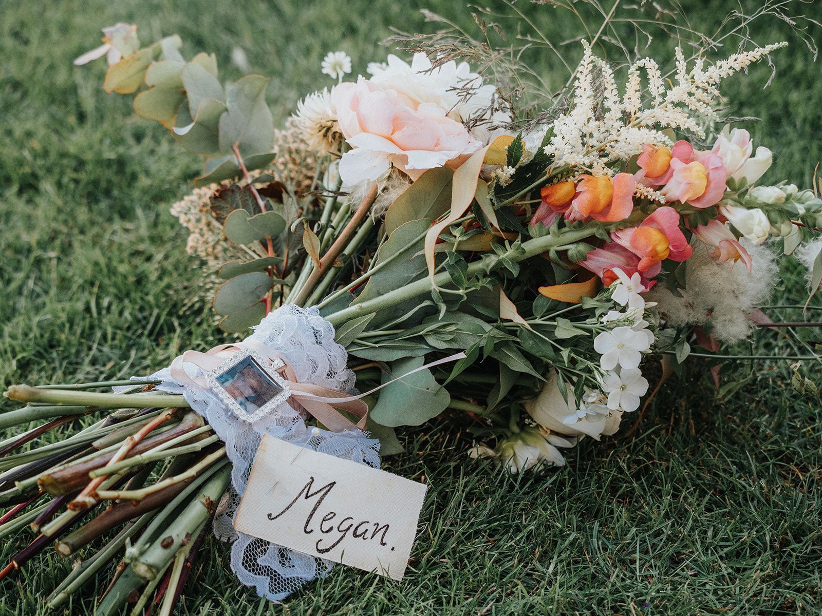 A bouquet of flowers with a card that says megan.
