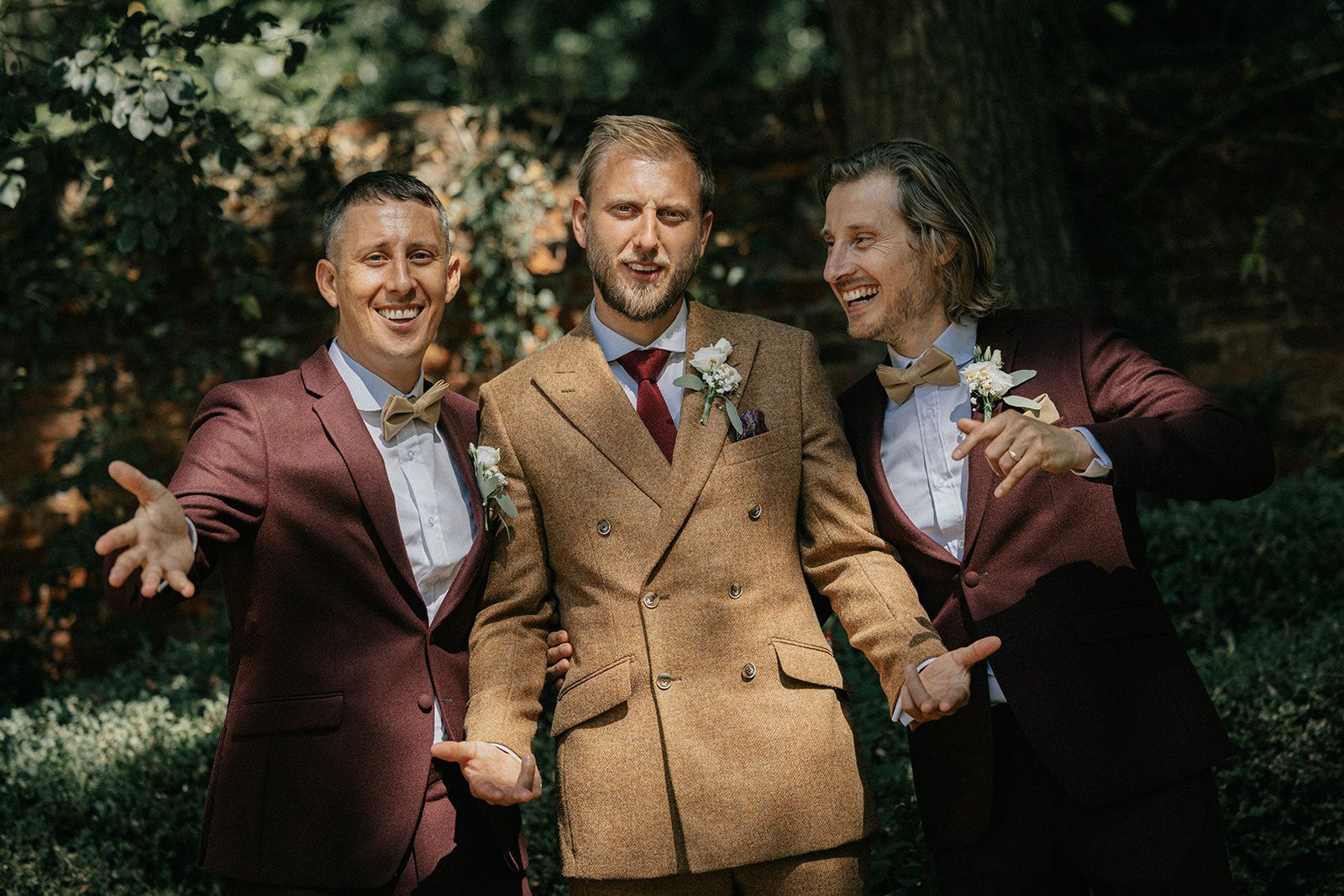 The groom and his groomsmen are posing for a picture together.
