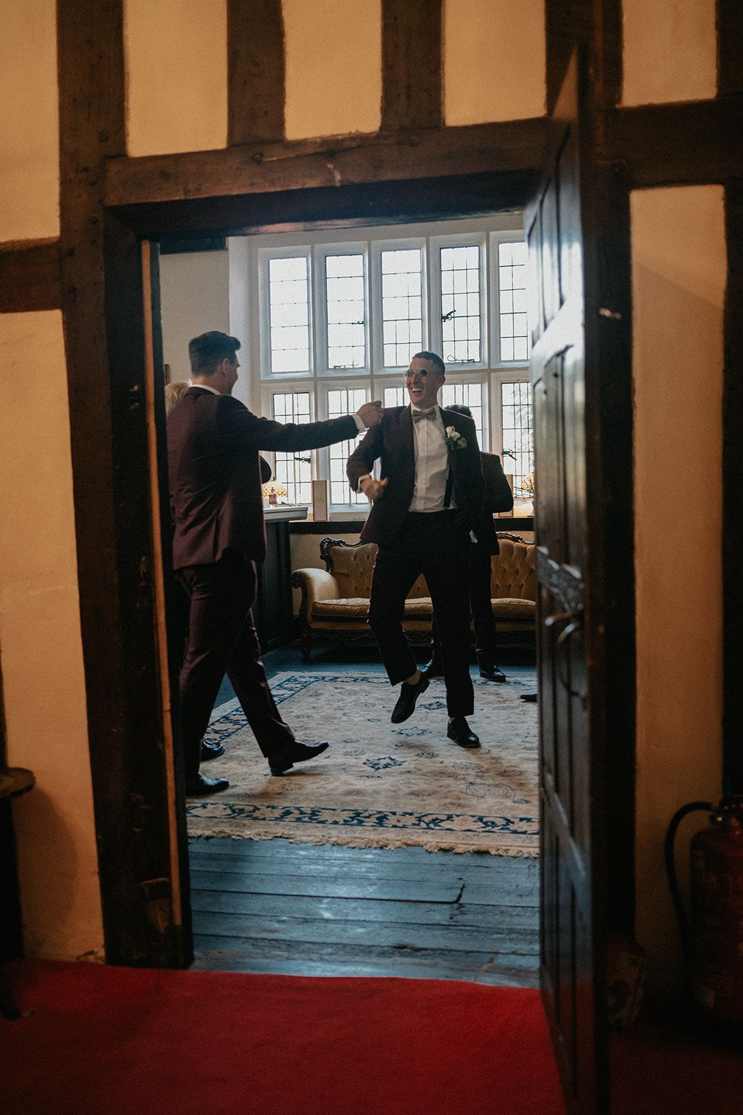 A group of men in suits are standing in a room.