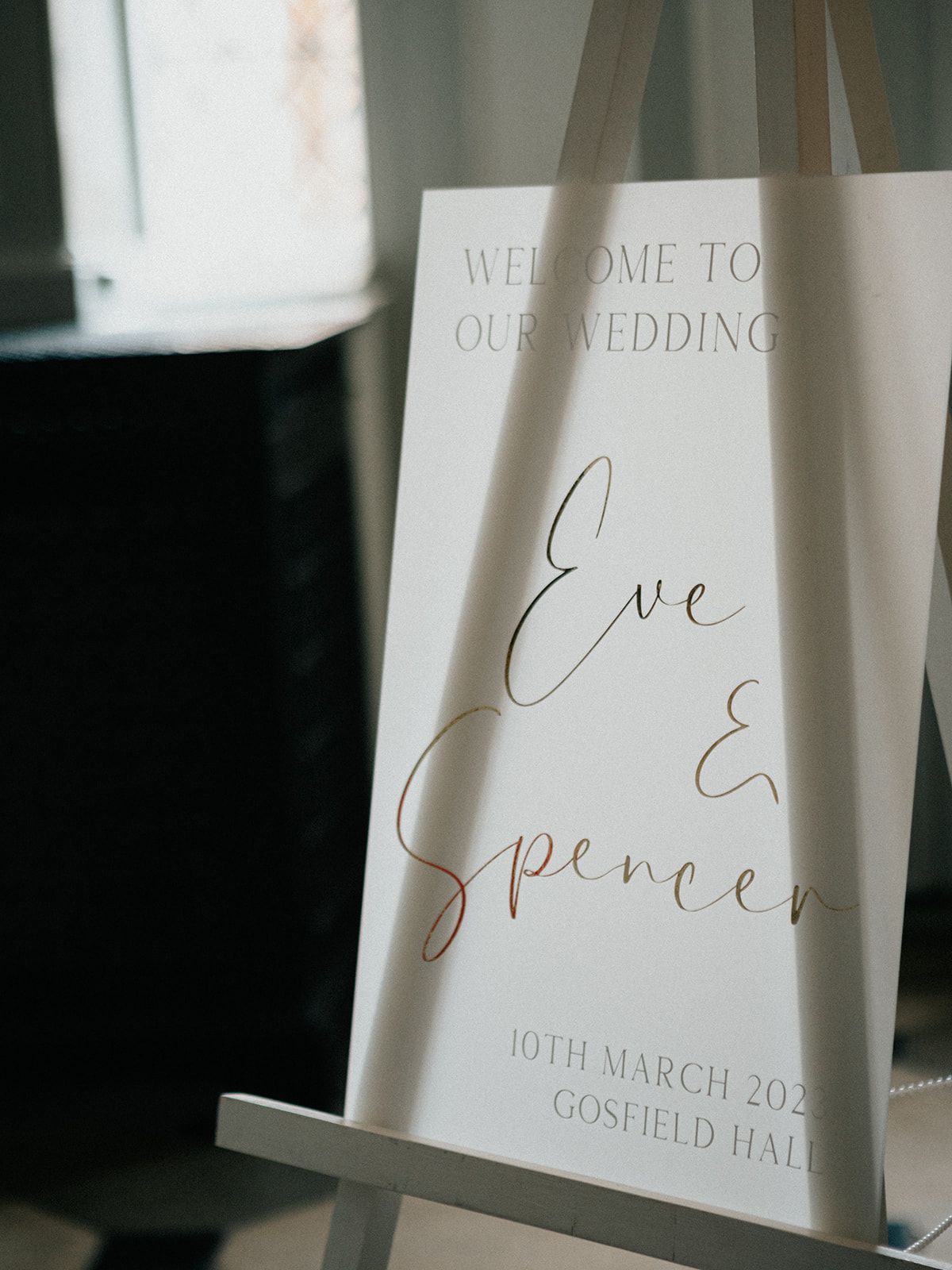 A welcome sign for eve and spencer is on an easel.