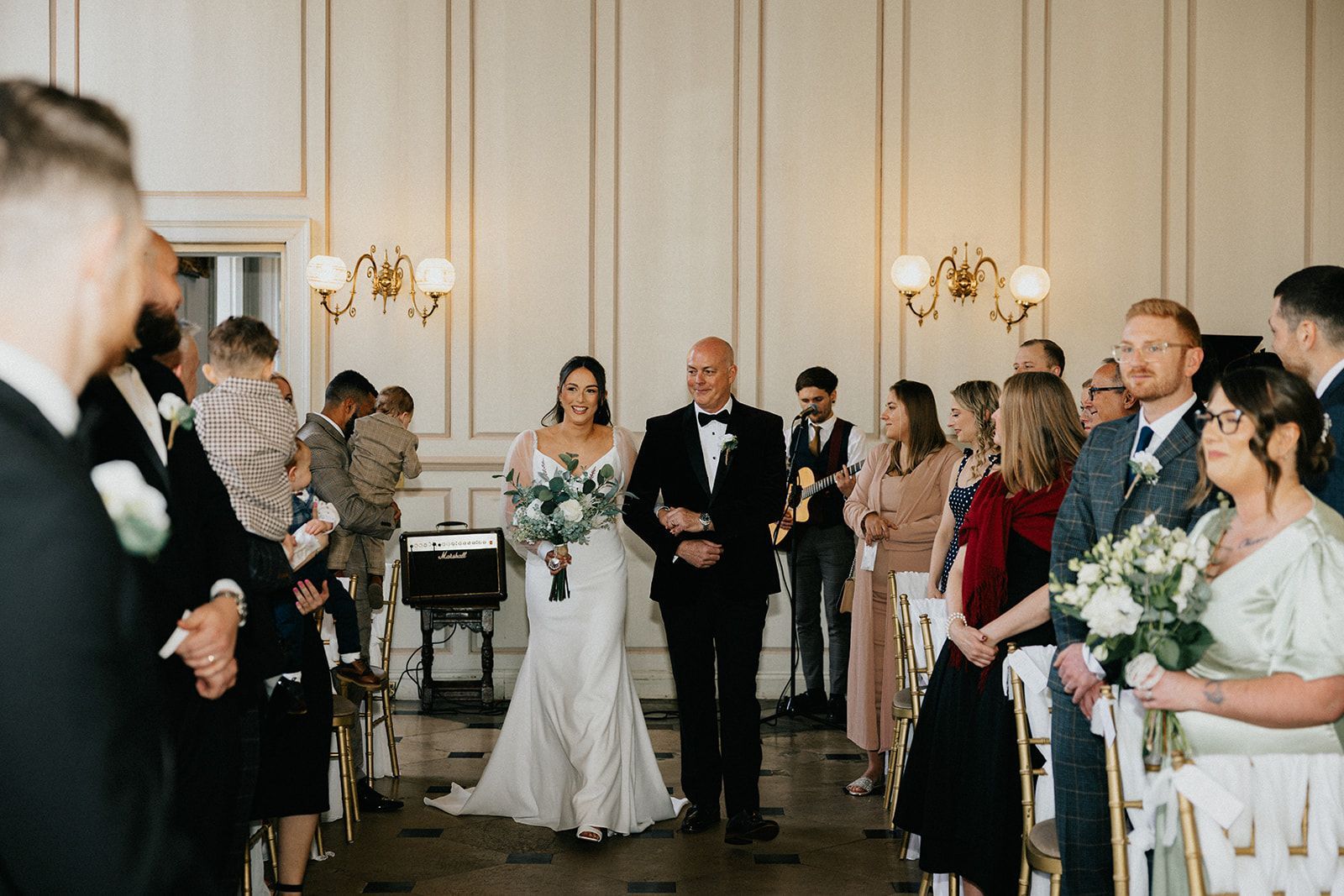 A bride and groom are walking down the aisle at their wedding ceremony.