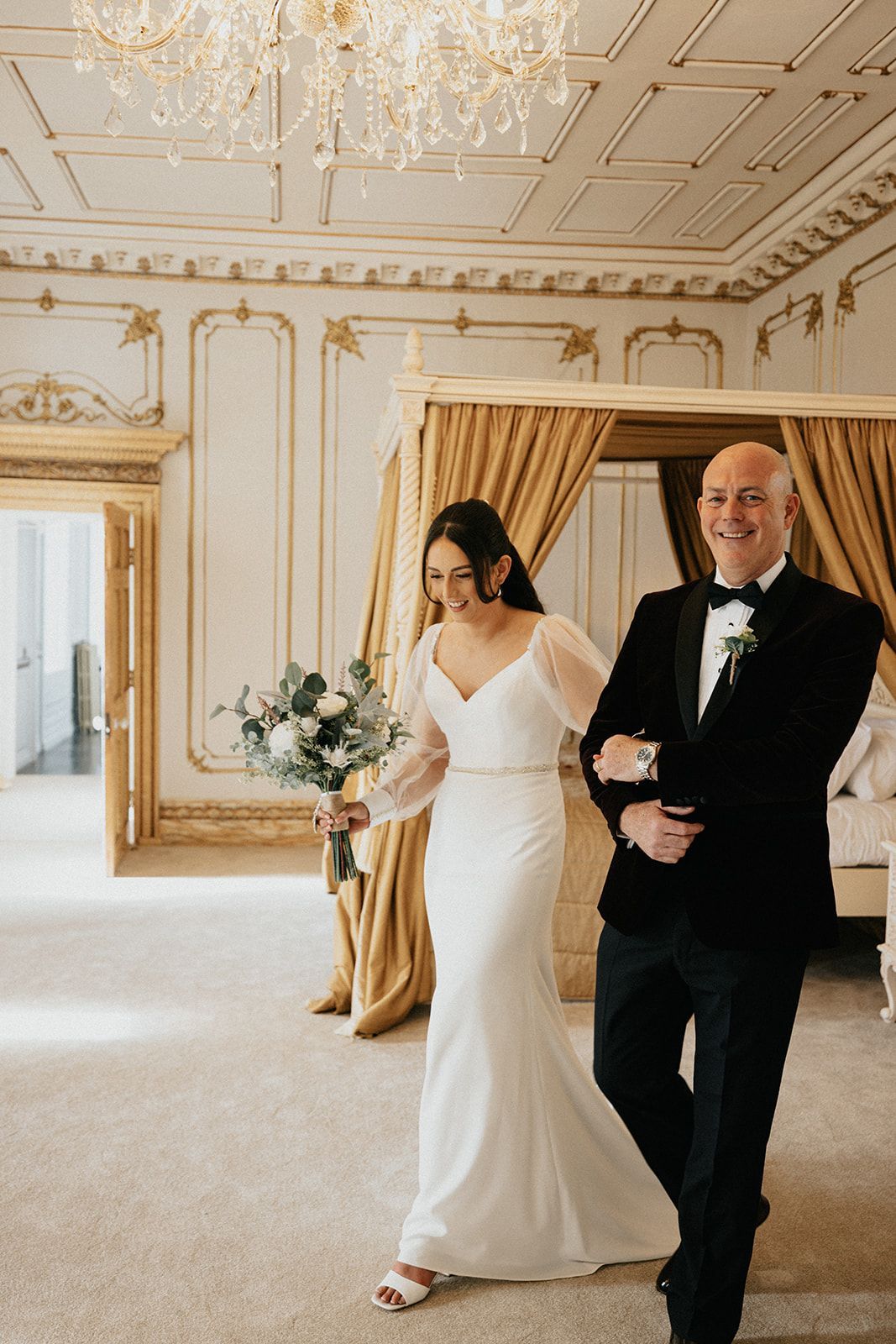 A bride is walking down the aisle with her father.