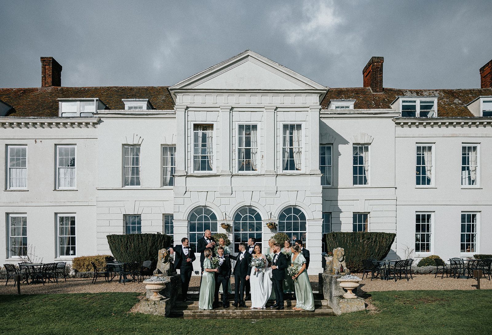 A group of people standing in front of a large white building.