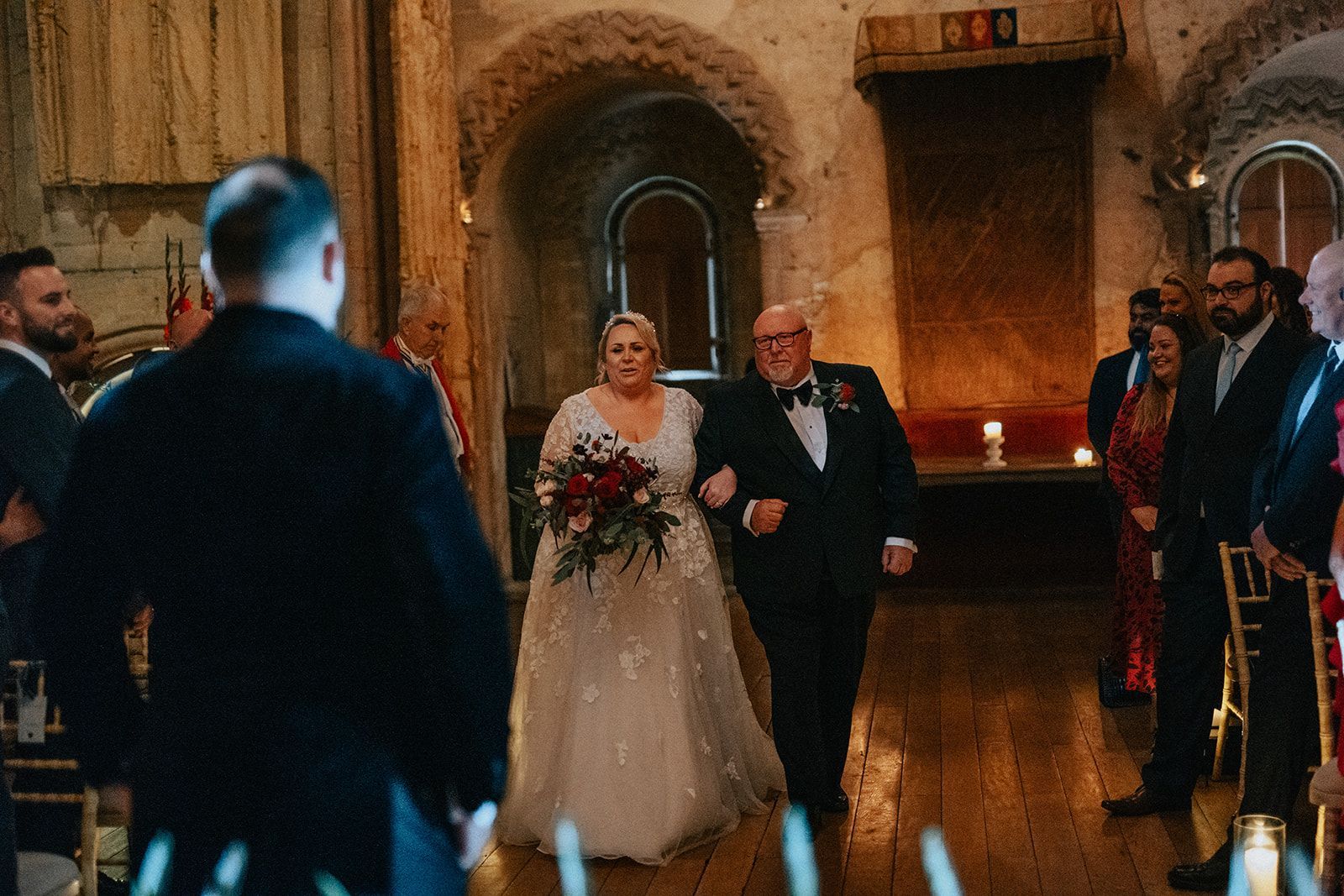 A bride and groom are walking down the aisle at their wedding.