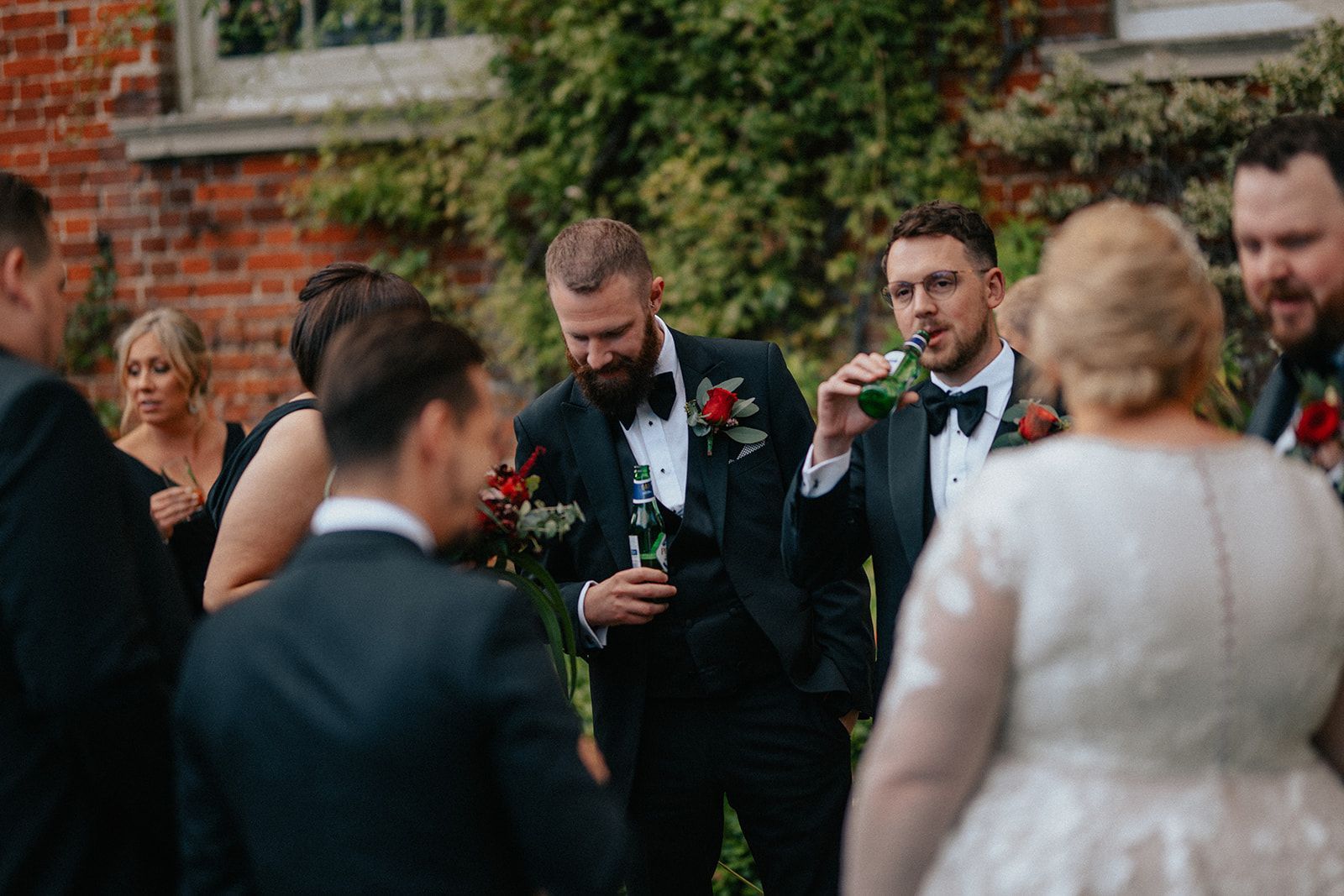 A group of people are standing around a bride and groom.