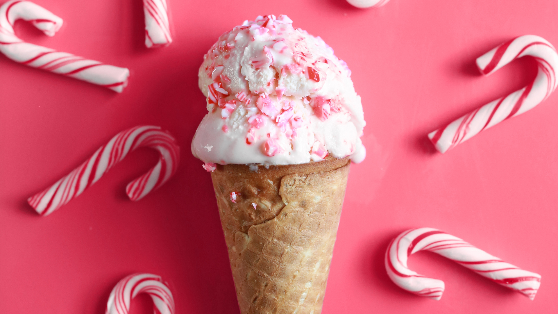 Slices of various cakes on a black surface, each with different flavors and toppings.