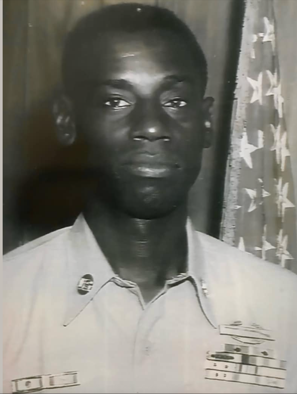 A black and white photo of a man in a military uniform