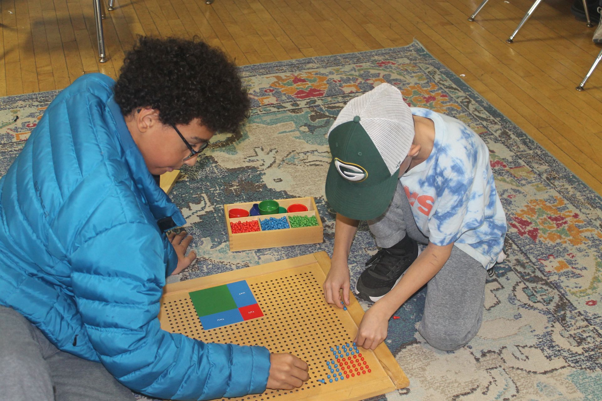 Montessori children working with math materials