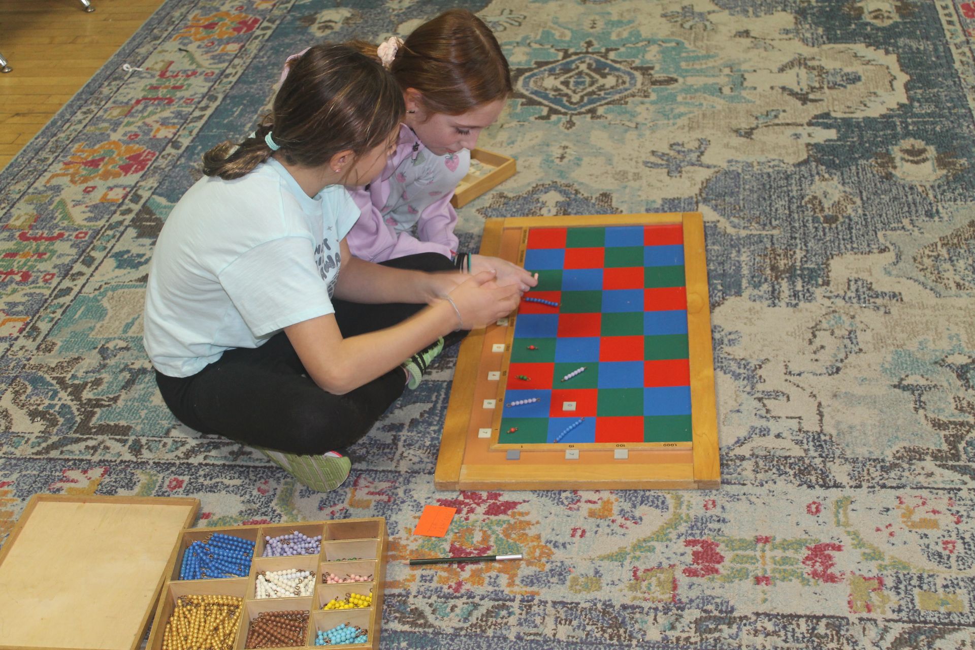 Montessori child working with math beads